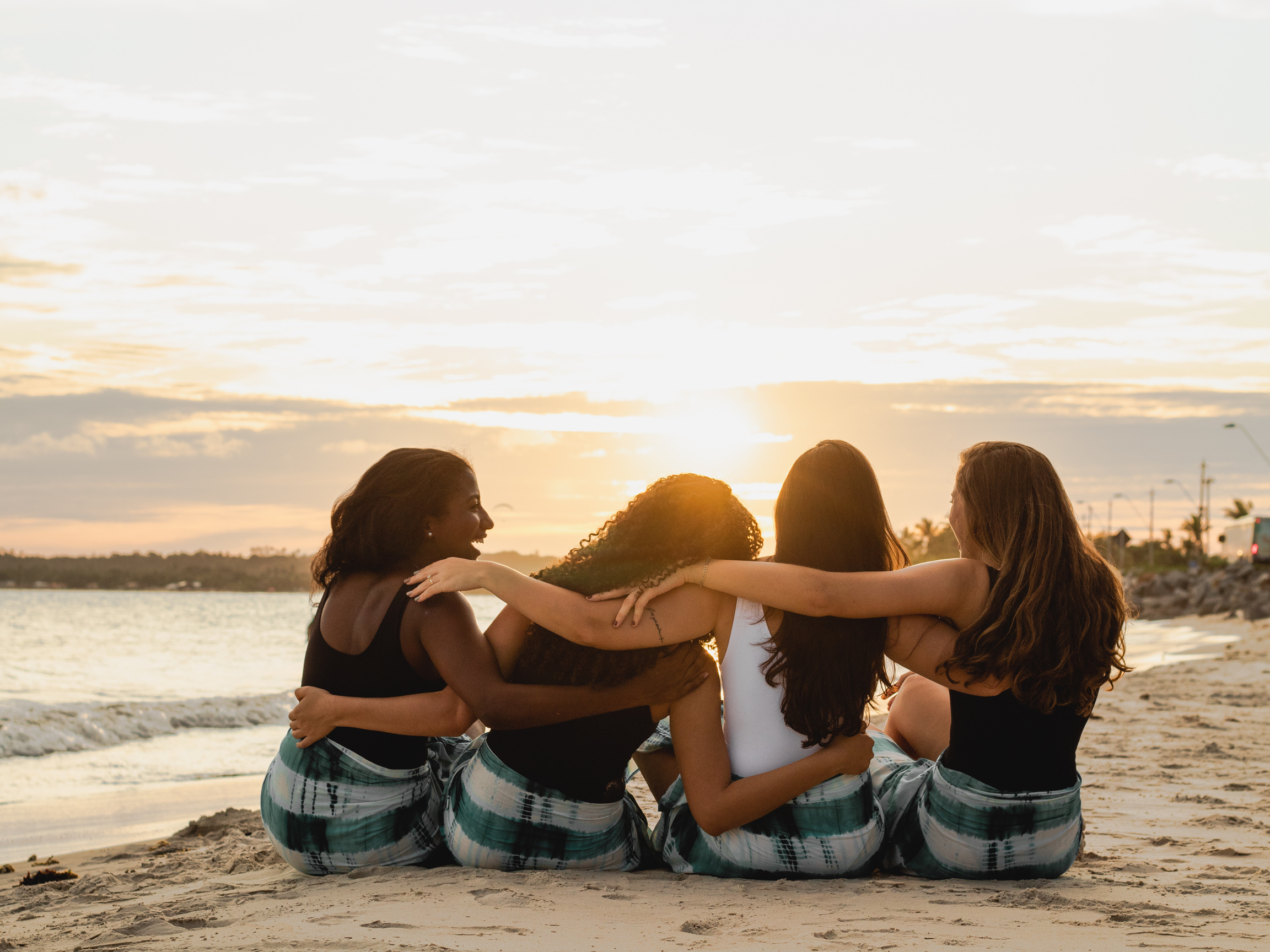 Back View of a Group of Women Sitting on the Beach